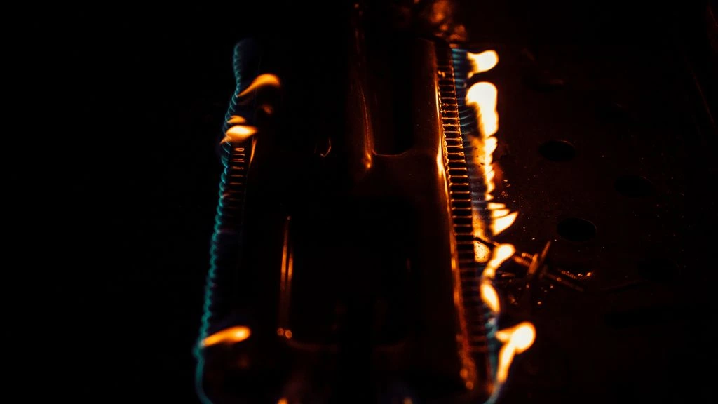 Blind Dog Smokin' offset smoker glowing with oak and pecan embers at night
