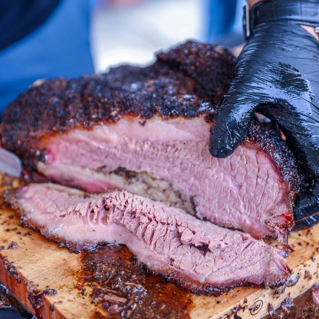 Sliced brisket showing dark bark and a deep smoke ring