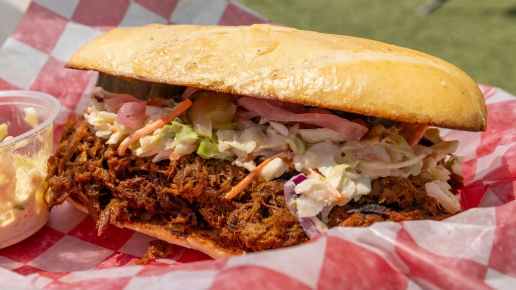 Hand-pulled pork shoulder with a dark bark.